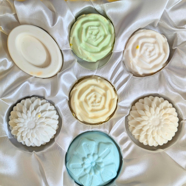 Assorted decorative soap bars on a textured white surface